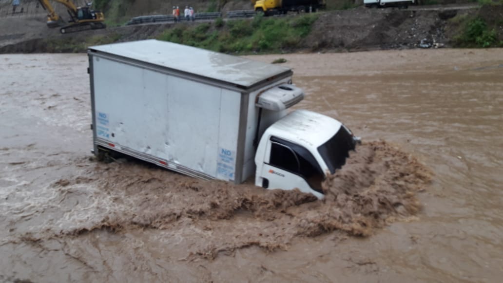 Camión y microbús arrastrados por corriente de río