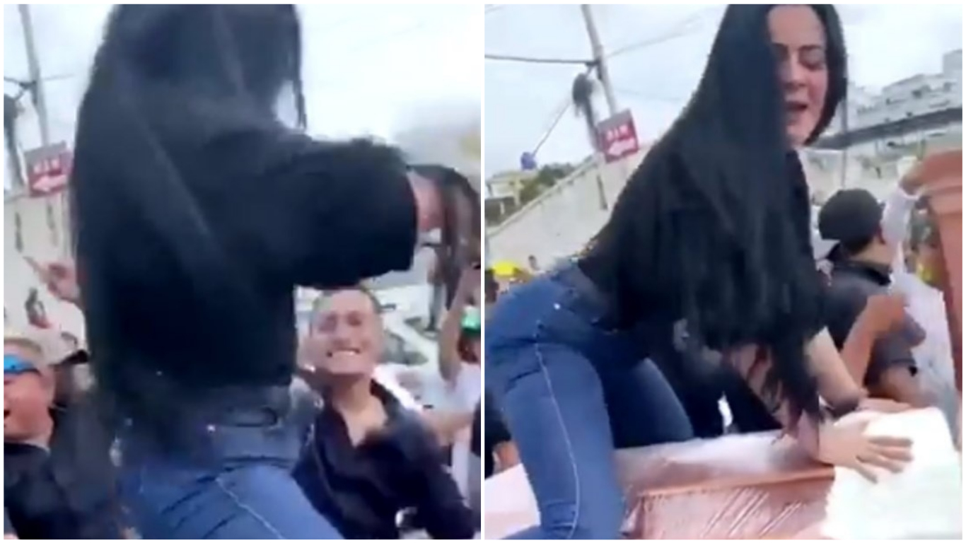 Mujer bailando reguetón sobre el ataúd de su esposo